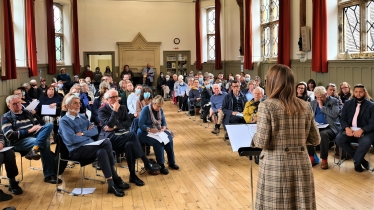 Helen addressing the public meeting